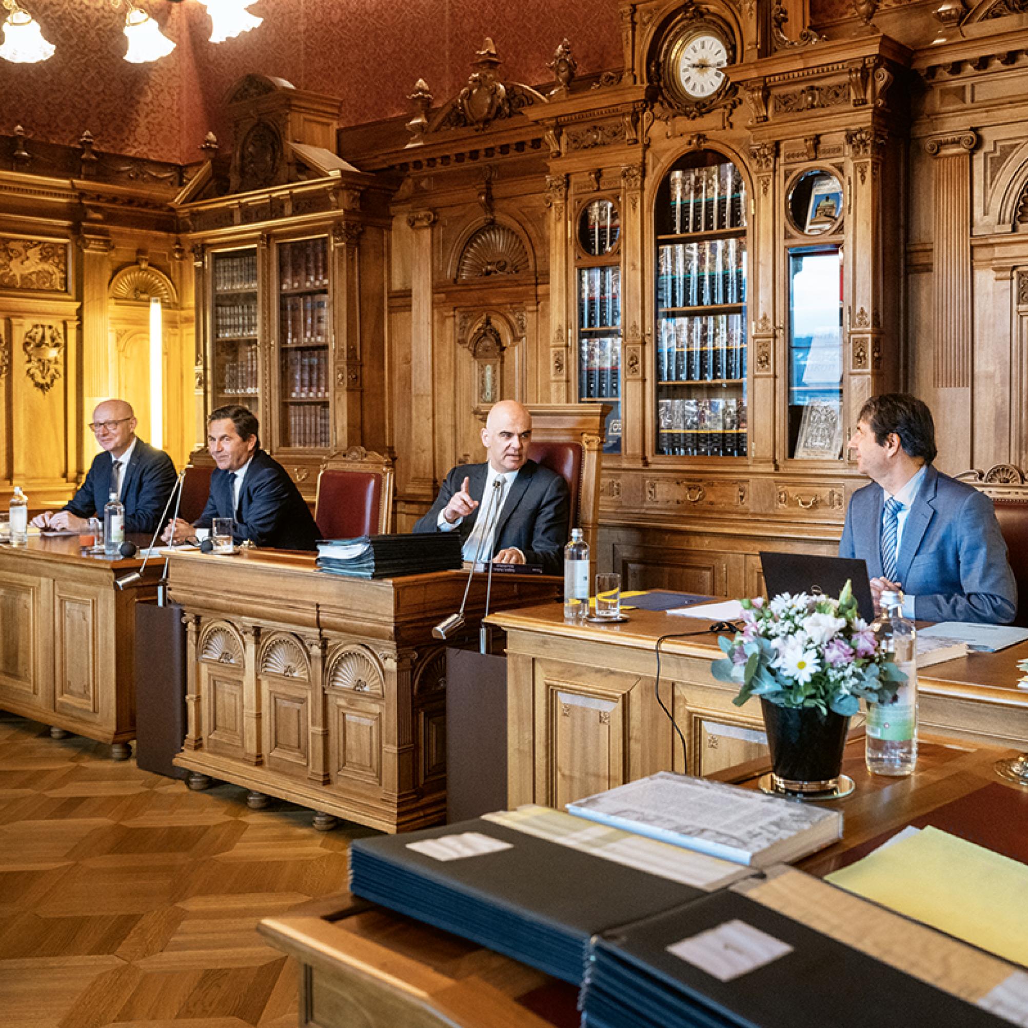 This photograph shows the Federal Council chamber. The Federal Chancellor and the two Vice Chancellors are seated to right and the left of the President.